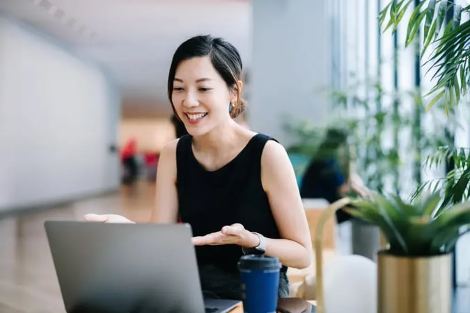 smiling lady in front of laptop